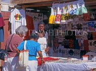 ANTIGUA, St John's, tourists shopping at souvenir clothing stall, ANT615JPL