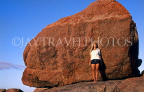 AUSTRALIA, Western Australia, 'Yalling Up' (place for lovers), woman posing by rock, AUS773JPL