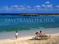 BAHAMAS, Paradise Island, beach, sunbathing couple and child, BAH351JPL