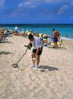 BAHAMAS, Paradise Island, tourist on beach with metal detector, BAH401JPL