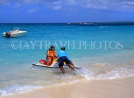 BAHAMAS, Paradise Island, tourist preparing for water scooter ride, BAH376JPL