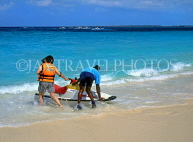 BAHAMAS, Paradise Island, tourist preparing for water scooter ride, BAH377JPL