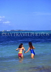 BAHAMAS, Paradise Island, two women walking into sea to swim, BAH229JPL