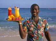 BAHAMAS, Paradise Island, waiter on beach with cocktails on tray, BAH395JPL