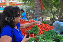 BAHRAIN, Budaiya, Farmers' Market, shopper at vegetable stall, BHR1248JPL