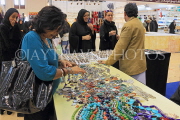BAHRAIN, Manama, Bahrain Exhibition Centre, Autumn Fair, shopper browsing, BHR1126JPL