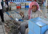 BAHRAIN, Manama, Central Market, Fish Market, vendor holding crab, BHR1894JPL