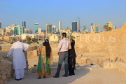 BAHRAIN, Manama, Karababad, Bahrain Fort (Qal'at al Bahrain), visitors, Manama skyline, BHR658JPL
