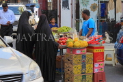 BAHRAIN, Manama Souk (souq), fruit stall and shoppers, BHR1098JPL