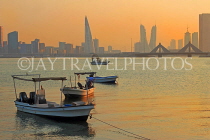 BAHRAIN, Muharraq, coastal fishing village area, boats, and Manama skyline, dusk, BHR2485JPL