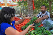 BAHRAIN, Noor El Ain, Garden Bazaar, Farmers Market, shopper at vegetable stall, BHR1249JPL