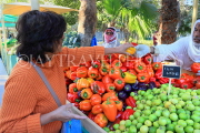 BAHRAIN, Noor El Ain, Garden Bazaar, Farmers Market, shopper at vegetable stall, BHR1788JPL