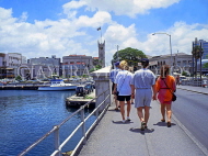 BARBADOS, Bridgetown, tourists on Chamberlain Bridge, government buildings, clocktower, BAR508JPL