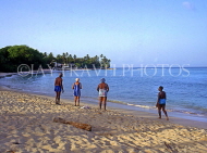BARBADOS, West Coast, Barbadians walking along beach, BAR468JPL