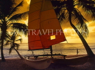 BARBADOS, West Coast, beach, sailboat and coconut trees, dusk, BAR528JPL