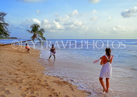 BARBADOS, West Coast beach, tourist playing beach ball, BAR456JPL