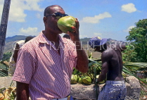BARBADOS, roadside stall, man drinking coconut water, BAR367JPL