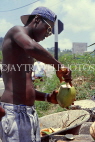 BARBADOS, roadside stall, man opening coconut (for drinking), BAR365JPL
