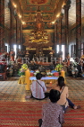 CAMBODIA, Phnom Penh, Wat Phnom, Main Hall, Budda statue and worshippers, CAM1960JPL