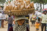 CAMBODIA, Phnom Penh, market vendor with basket on her head, CAM80JPL