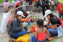 CAMBODIA, Phnom Penh, street food, people enjoying food bought from vendor, CAM2096JPL