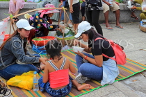 CAMBODIA, Phnom Penh, street food, people enjoying food bought from vendor, CAM2097JPL