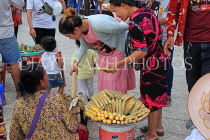 CAMBODIA, Phnom Penh, street food, small stall vendor selling snacks, CAM2085JPL