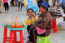 CAMBODIA, Phnom Penh, street food, small stall vendor selling sweet snacks, CAM2086JPL
