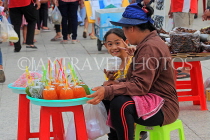 CAMBODIA, Phnom Penh, street food, small stall vendor selling sweet snacks, CAM2087JPL