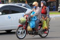 CAMBODIA, Phnom Penh, street scene, traffic, couple on bike loaded with goods, CAM1832JPL