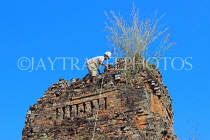 CAMBODIA, Siem Reap, Angkor, Pre Rup Temple, worker clearing ruins, CAM1075JPL