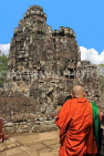 CAMBODIA, Siem Reap, Angkor Thom, Bayon Temple, stone faces & Buddhist monk, CAM818JPL