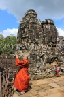 CAMBODIA, Siem Reap, Angkor Thom, Bayon Temple, stone faces & Buddhist monk, CAM819JPL