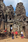 CAMBODIA, Siem Reap, Angkor Thom, Bayon Temple, stone faces, and tourists, CAM826JPL