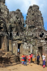 CAMBODIA, Siem Reap, Angkor Thom, Bayon Temple, stone faces, and tourists, CAM827JPL