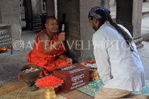 CAMBODIA, Siem Reap, Angkor Wat, Buddhist monk giving blessings, CAM513JPL