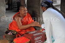 CAMBODIA, Siem Reap, Angkor Wat, Buddhist monk giving blessings, CAM515JPL