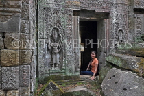 CAMBODIA, Siem Reap, Ta Prohm Temple, bas-relief Devata figure, and tourist, CAM1435JPL