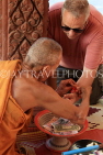 CAMBODIA, Siem Reap Prov, Kulen Mountain, Wat Preah Ang Thom, monk blessing tourist, CAM2430JPL