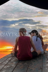 CAMBODIA, Tonle Sap Lake, tourist couple enjoying the sunset view from boat, CAM931JPL