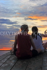 CAMBODIA, Tonle Sap Lake, tourist couple enjoying the sunset view from boat, CAM932JPL