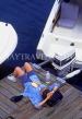 CANADA, British Columbia, VANCOUVER, Granville Island, woman relaxing by quayside, CAN646JPL