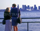 CANADA, British Columbia, VANCOUVER, Lonsdale Quay, couple looking towards Downtown, VAN936JPL