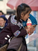 CHINA, Yunnan Province, Yuanyang, Hani tribe girl eating ice cream, Shalatou market, CH1546JPL