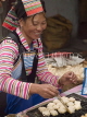 CHINA, Yunnan Province, Yuanyang, Yi tribe woman roasting tofu, CH1465JPL