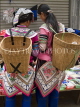 CHINA, Yunnan Province, Yuanyang, Yi tribe women with baskets, at market, CH1576JPL