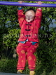CHINA, Yunnan Province, Yuanyang, girl in red suit, swinging, CH1666JPL