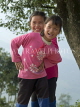 CHINA, Yunnan Province, Yuanyang, two childrren (sisters) posing playfully, CH1556JPL