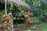 COOK ISLANDS, Rarotonga, Cultural Village, Maori man explaining uses of coconut, CI915JPL