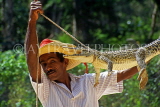 CUBA, Guama, man demonstrating traditional method of trapping crocodile, CUB271JPL